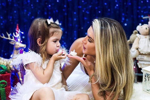 valentina e mirella posam juntas segurando uma vela na mão