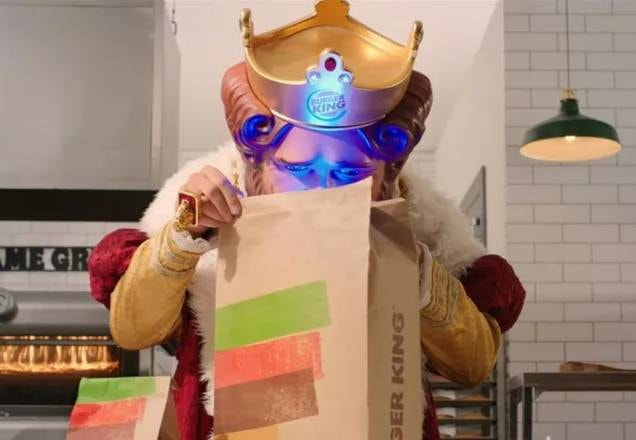 Rei do Burger King olhando dentro de um saco premiado