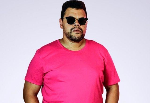 Babu Santana, de camisa rosa e óculos escuros