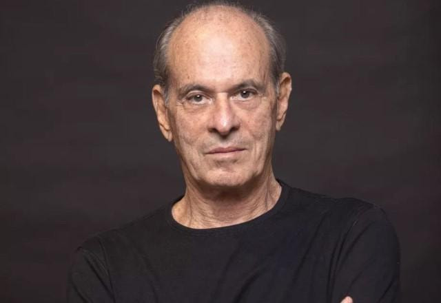 Ney Matogrosso de camisa preta em um fundo preto