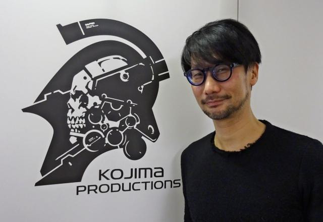 Foto de Hideo Kojima ao lado do logo da Kojima Productions