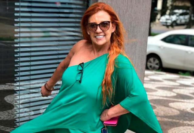 Rita Cadillac, de verde, em frente a uma banca de jornal