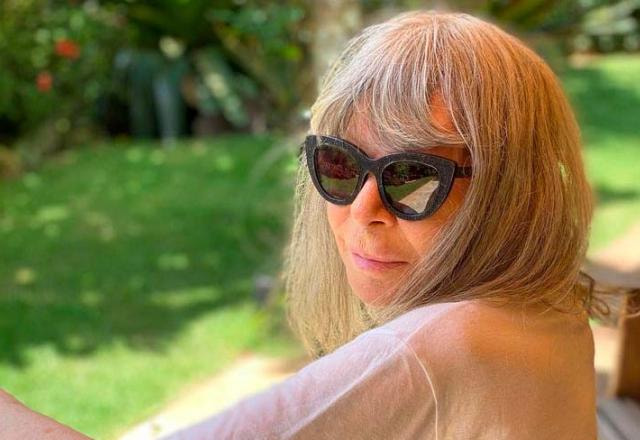 A cantora Rita Lee posa de óculos em jardim