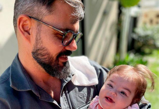 Juliano Cazarré com Maria Guilhermina no colo