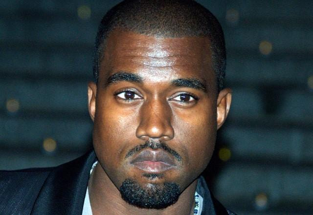 Kanye West posa olhando sério para frente