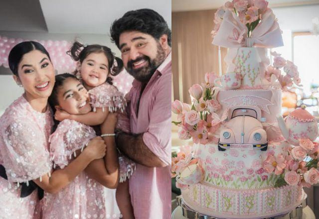Na foto temos a família completa ao lado do bolo rosa com temática de fusca e flores