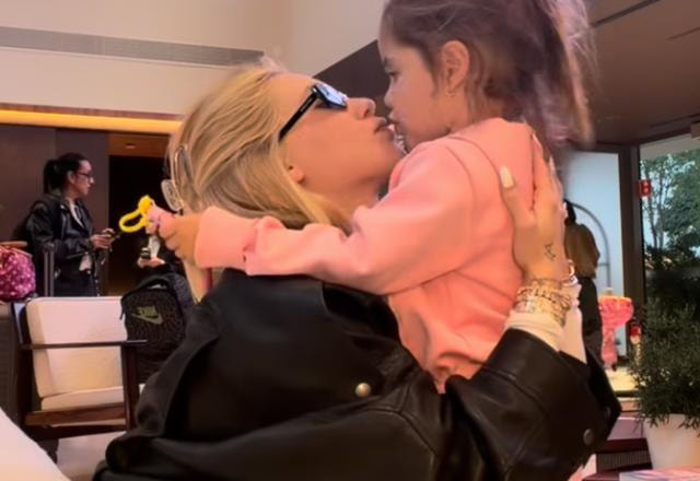 Na foto, Virginia se despende de sua filha abraçando e dando um beijo